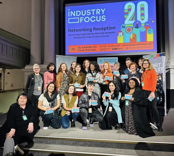 group photo of Filmonomics alumni in front of a screen reading 
Industry Focus Networking Reception 