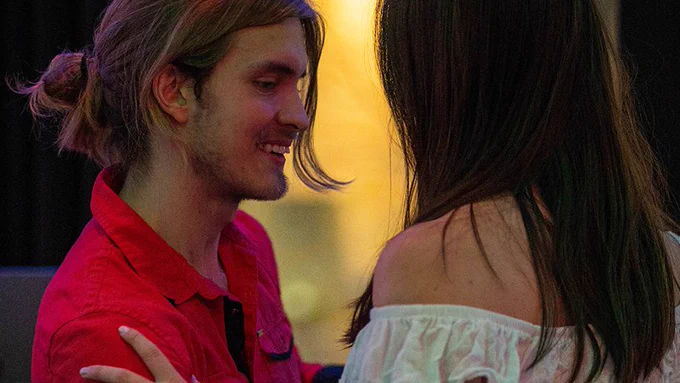 President of the Social Dance Club at Penn State, Victor dances with a female student at an event on campus.
