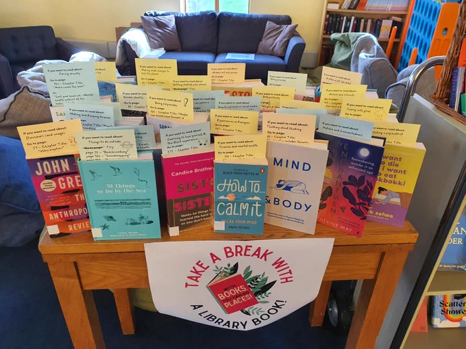 A selection of Library books standing on a table, with recommendation cards sticking out of their tops.