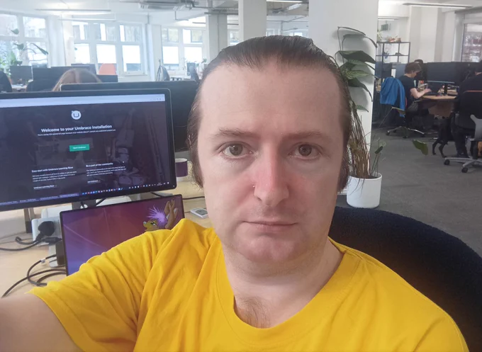 Selfie sat behind a desk at True Digital
