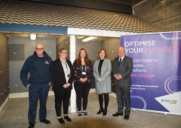 Five people are pictured in front of a banner which says 'optimise your future'