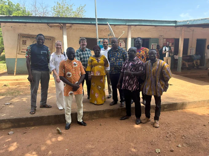 Researchers from Southampton and the University for Development Studies, with the Mion health team stand together smiling outside.