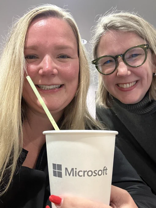 Jenny and Jessica selfie with holding a Microsoft branded coffee cup and a straw