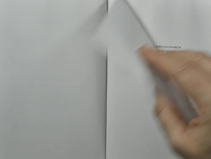 Hand turning page.