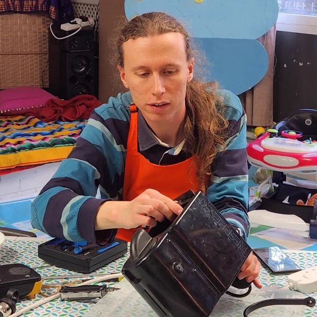 Photo of a person at a previous Fixing Factory event repairing an electrical item