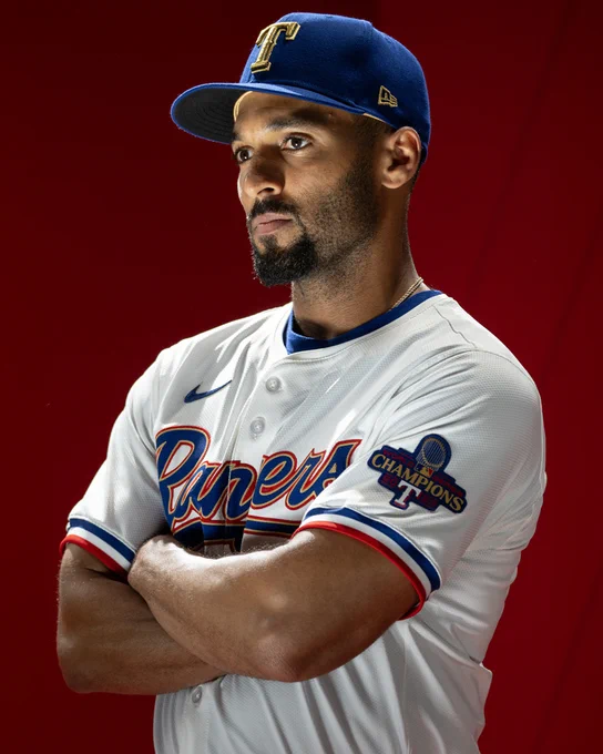 Marcus Semien wearing the Rangers World Series Champion gold uniform 