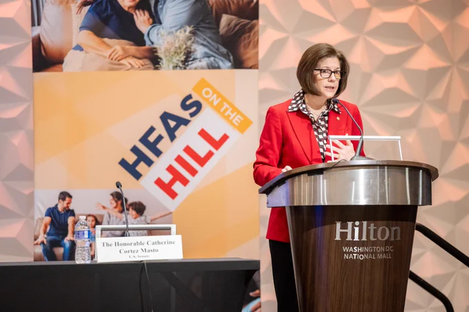 Senator Catherine Cortez Masto speaking at the NCSHA 2024 Legislative Conference with #HFAsOnTheHill sign in the background