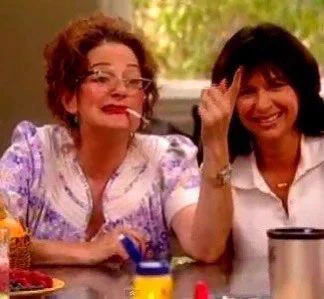 Hazel with a cigarette in her mouth serving c in the Magic Bullet infomercial.