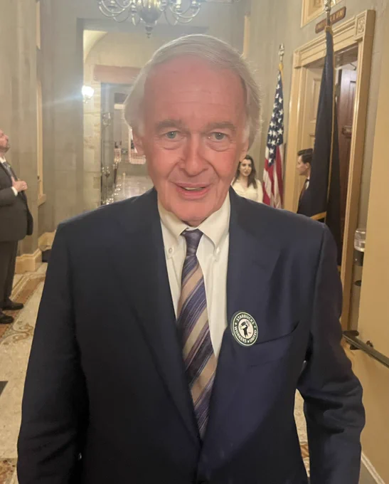 Senator Markey stands smiling with a Starbucks Workers United pin