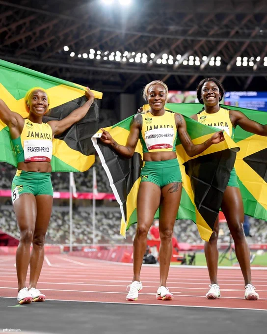 From left to right, Shelly-Ann Fraser-Pryce, Elaine Thompson-Herah and Shericka Jackson of Team Jamaica celebrate after completing a podium sweep in the Women's 100m Track and Field Final