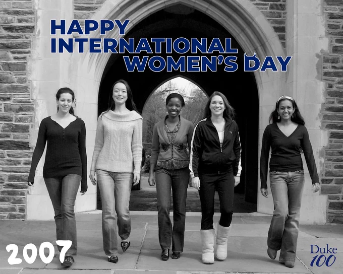 A different photo of five women walking under the same stone archway at Duke. The year 2007 is written in the corner with the text "happy international women's day" at the top