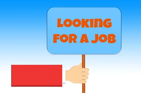 An arm and hand coming out of the image from left to right holding a sign. The sign says 'looking for a job'.  Image by Gerd Altmann from Pixabay