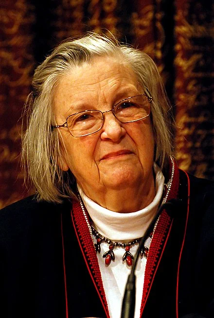 Ostrom in 2009. A white women in her 70s, with white hair and glasses