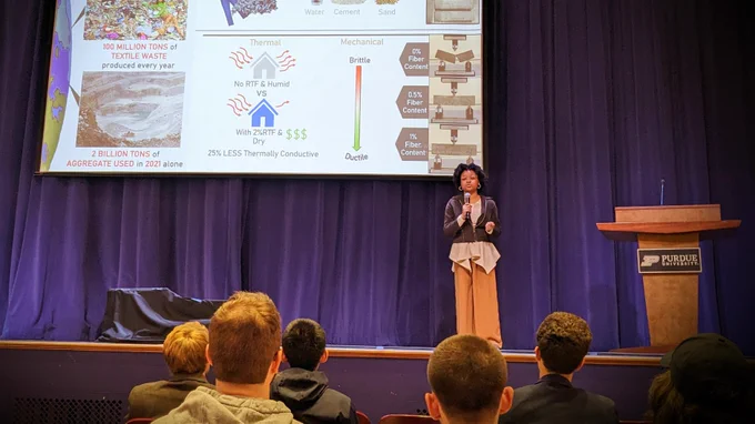 Aniya presenting a research slide to an audience.