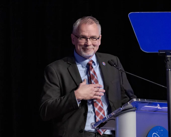 NASA Associate Administrator Jim Free smiles while giving a commencement speech during the 2024 NASA Astronaut Graduation ceremony held in the Teague Auditorium at NASA's Johnson Space Center.