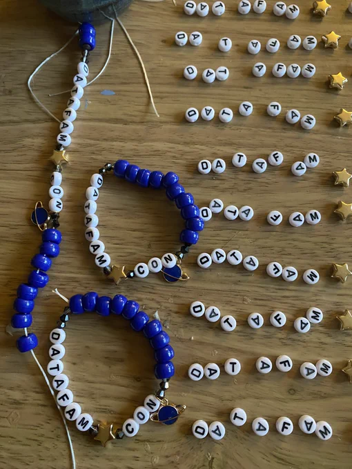 Work in progress picture of handmade friendship bracelets that say, “DataFam Con”