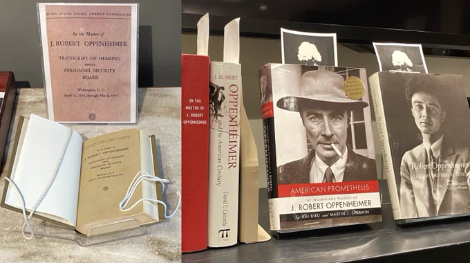 Photo of book opened to title page (Oppenheimer hearing), and several books on cart (including American Prometheus).