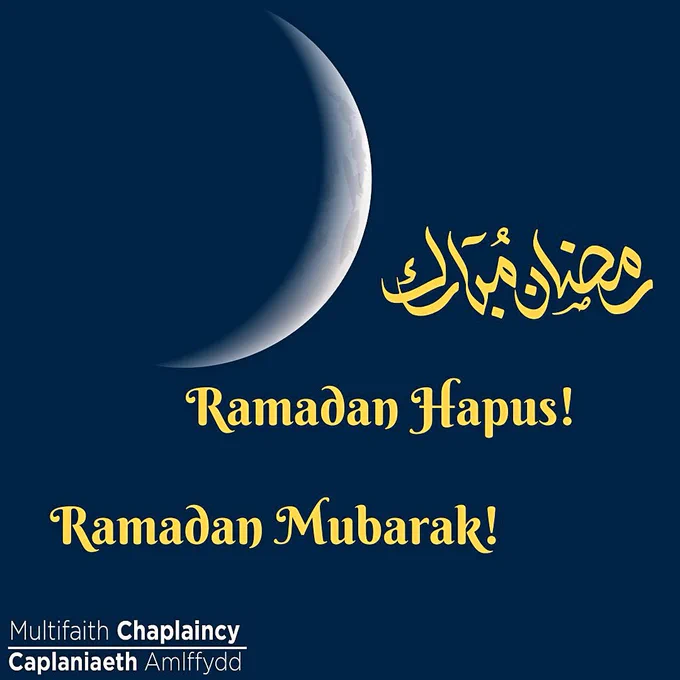 Blue background with crescent moon. Text in gold says Ramadan Mubarak in Arabic and English text. Ramadan Hapus