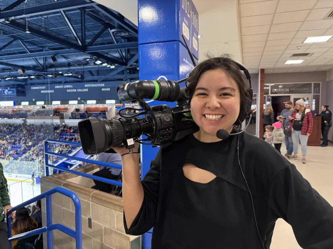 Lauren Yee ‘24 holding a video camera at the PWHL game.