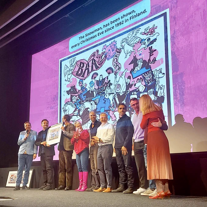 Kensuke's Kingdom team on stage accepting award. 