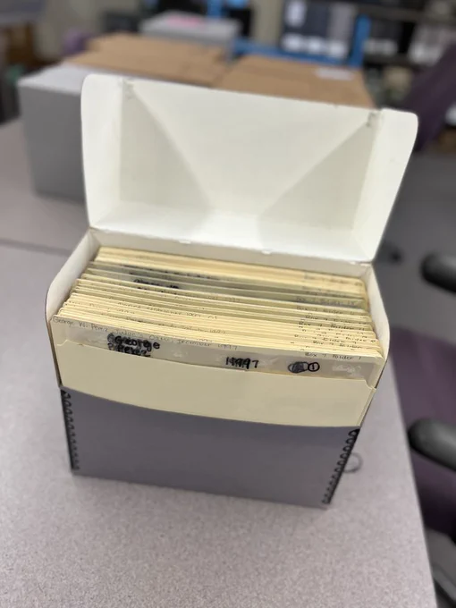 Box of processed prints placed inside a gray archival box.