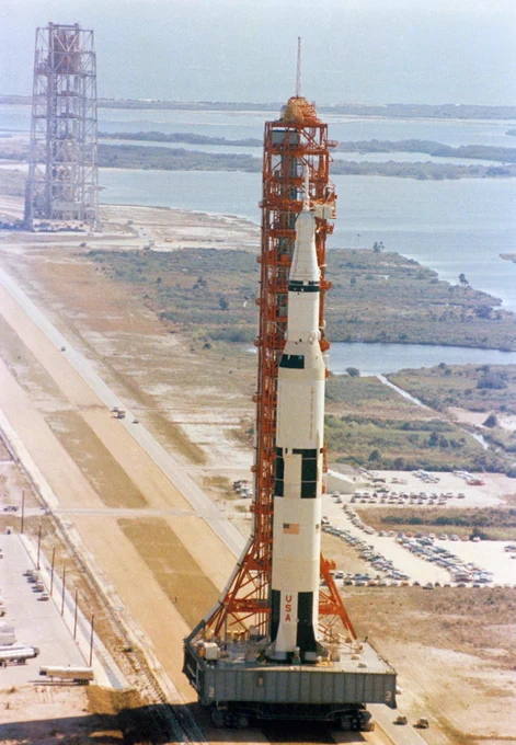 Aerial view at Launch Complex 39, Kennedy Space Center, showing the 363-foot tall Apollo 10 (Spacecraft 106/Lunar Module 4/Saturn 505) space vehicle on its way to Pad B. The Saturn V stack and its mobile launch tower are atop a huge crawler-transporter. The Apollo 10 flight launched 2 months later on May 18, 1969.