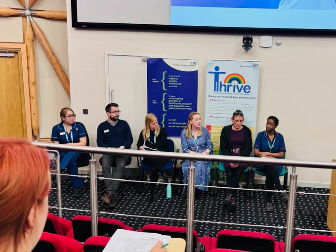 Six expert panellists seated at the front facing the audience