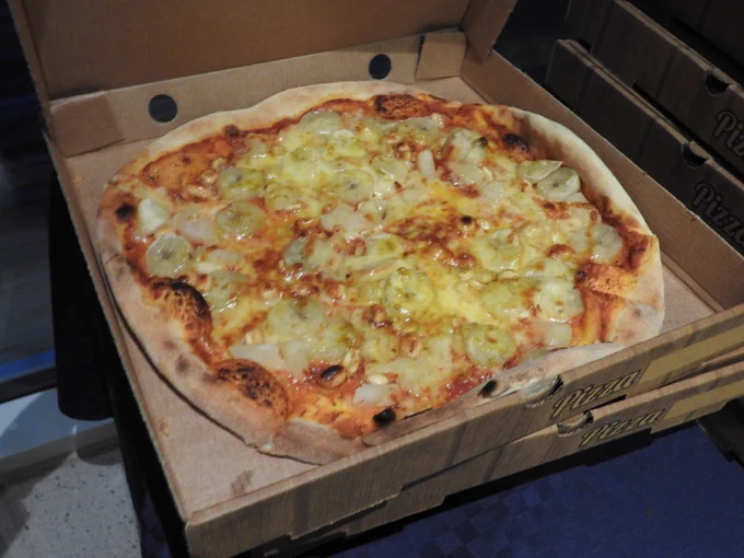 Swedish pizza from the pizza social event with banana, pineapple, peanuts, and curry.