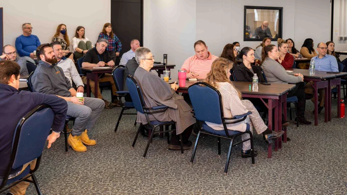 New York State Office of General Services Procurement Team members sit together during a Town Hall.