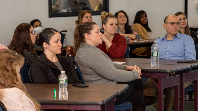 New York State Office of General Services Procurement Team members sit together during a Town Hall.