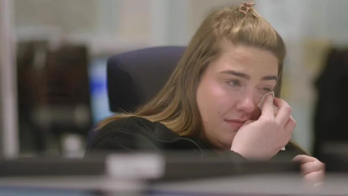 Dispatcher Natalie wiping tears away with a tissue,
