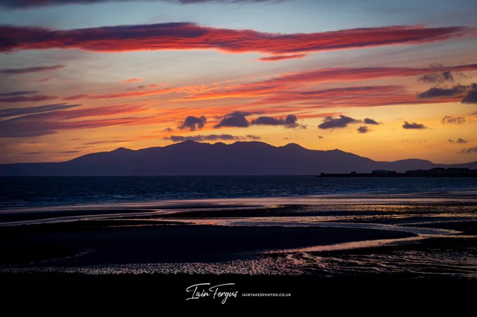 Sunset with red clouds over the Isle of Arran taken from Stevenston beach.