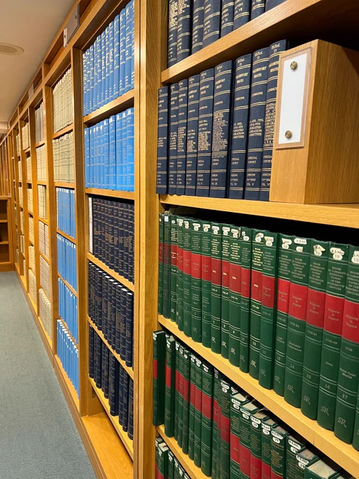A photo of the open shelves filled with official publications in the Social Sciences Reading Room at the British Library's St Pancras site.
