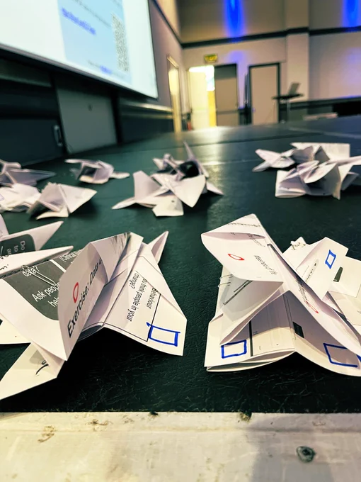 A pile of paper aeroplanes on a stage