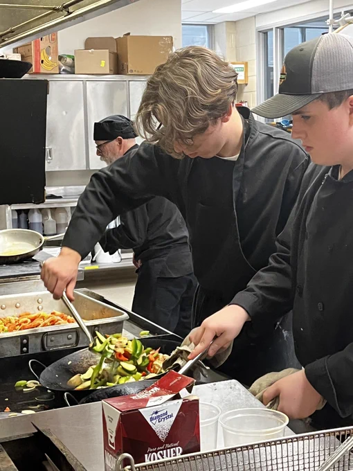 Students cooking a stir fry.
