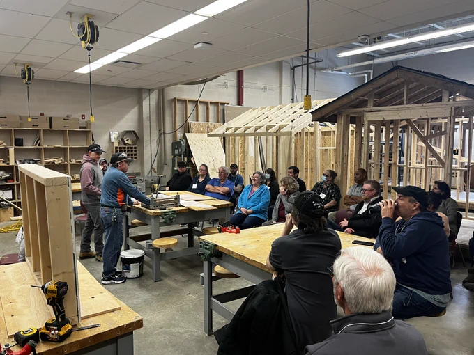 People gathered in a shop classroom for professional development.