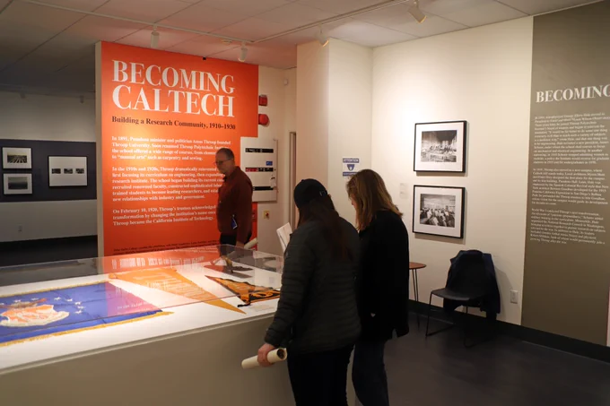 Visitors explore the Becoming Caltech exhibit organized by Caltech Archives