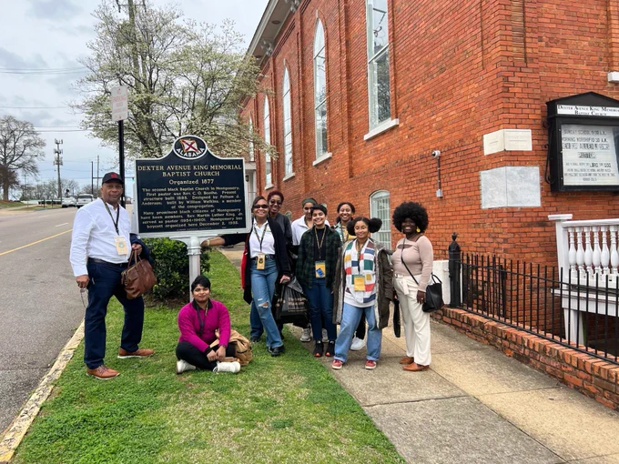 A group picture of the NOVA group standing next to the Dexter Avenue King Memorial Baptist Church.