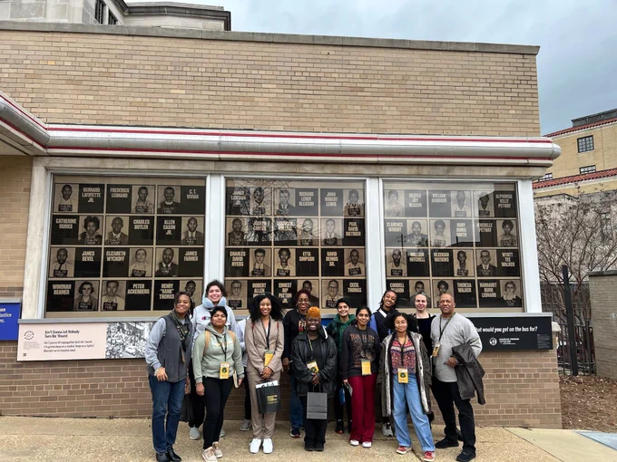 The NOVA group standing outside one of the sites on their tour.