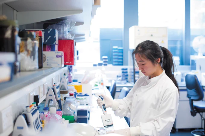 Female technician working in science lab