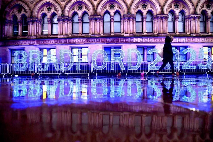 A light display in front of City Hall in Bradford. The lights spell out 'Bradford 2025'. Someone is walking past in the shot. 