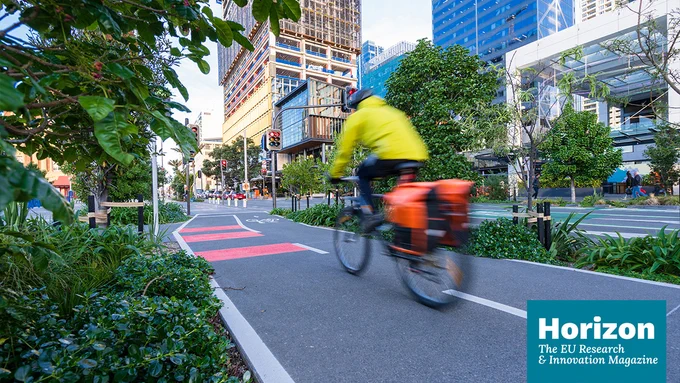 Man riding a bike in urban landscape and the Horizon Magazine logo at the bottom.