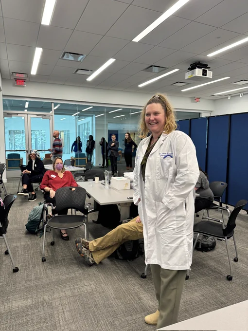 Jenn Fretter showing the Dr. Watt R Shedd lab coat. 