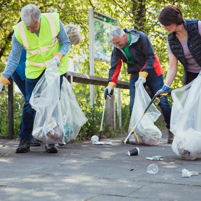 A photograph of a group of people litter-picking. 