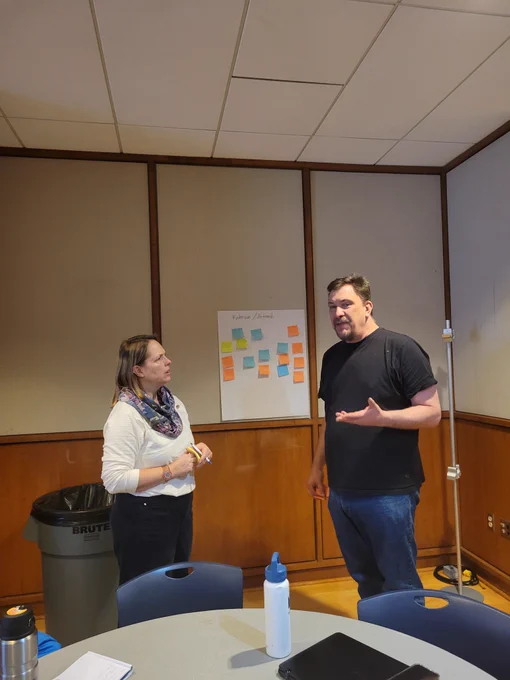 Two individuals discussing co.munity engagement and extension opportunities. 