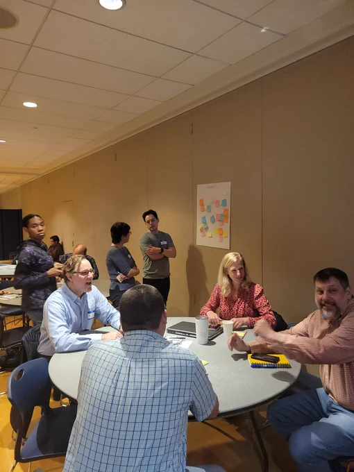 Individuals having conversations about Penn State water research. 