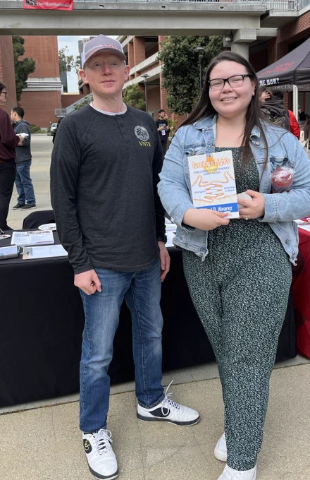 Oscar (MSNE Office) & Mental Health Advocate displaying "Turning on The Lights" by Rafael D. Alvarez. Several students took a free copy of the book with them yesterday.