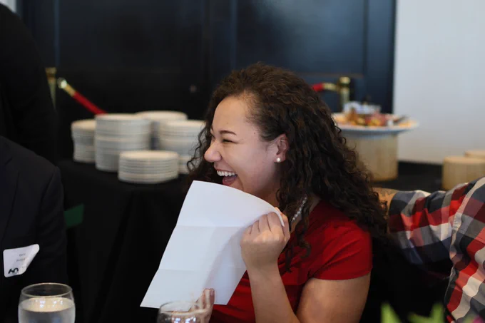 Smiling medical student holds letter than contains Match Day results