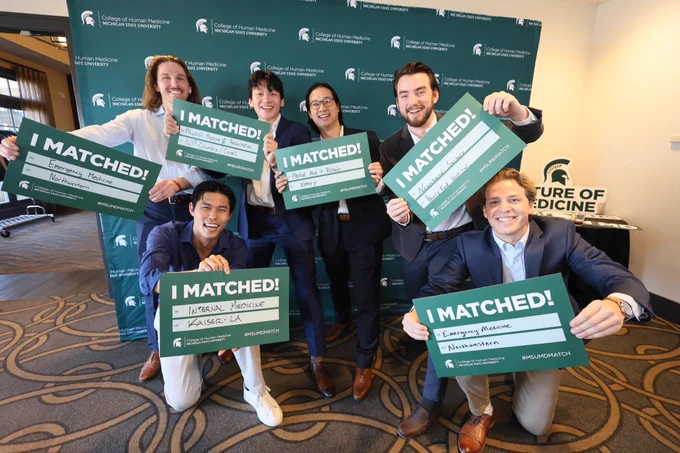 Group of medical students holding their Match Day signs