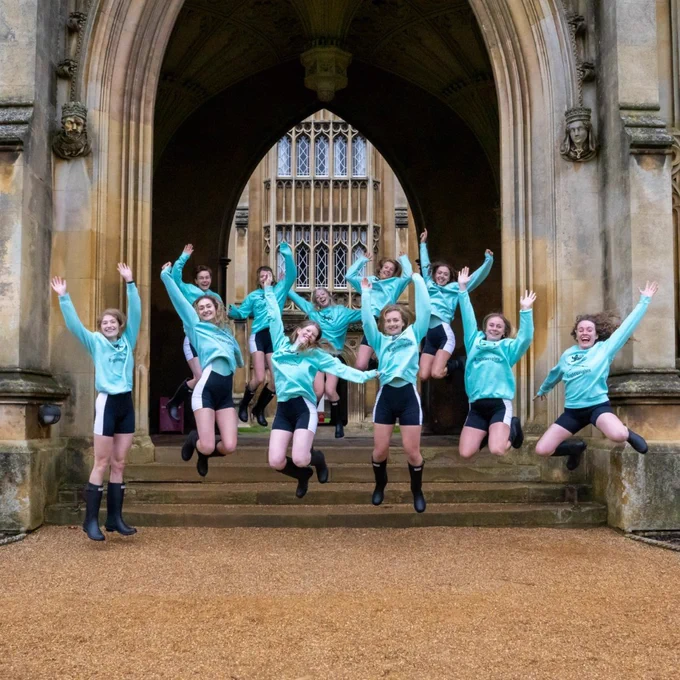 The Ladies Lightweight crew jump in the air wearing their light blue race kit.
